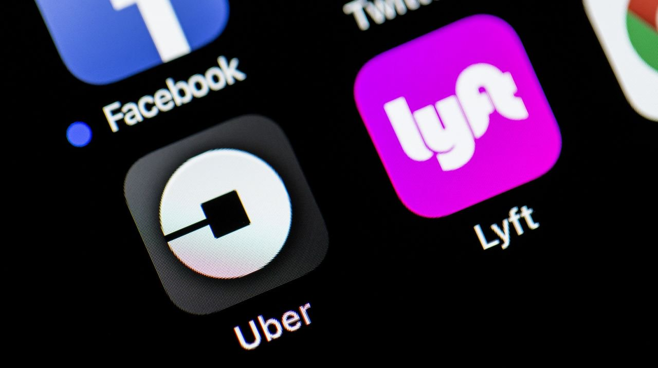cell phone screen showing Uber and Lyft app icons